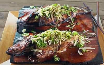 grilled bass with an asian mix spread over 2 fish