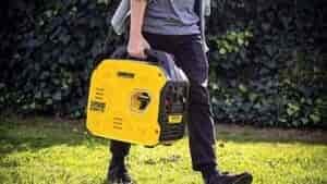 champion portable generator carried by man