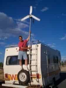 man installing wind generator on rv