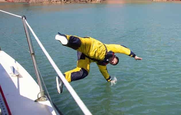 man falling overboard on sailboat for training others how to rescue overboard people.