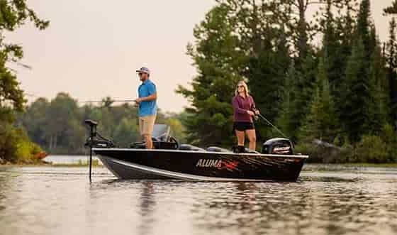 man and woman fishing in a alumacraft classic series black fishing boat