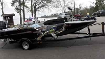 bass boat with large crash side missing most of right side of boat