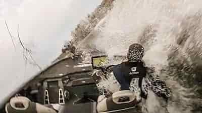 man driving bass boat in sharpe turn in rough water splash everywhere 1