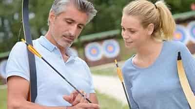 women getting archery lesson about brace height