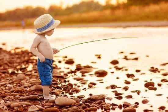 canva adorable baby on river with fishing rod and fishing MADarFcNnBQ
