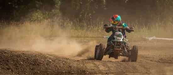 young boy riding atv in race