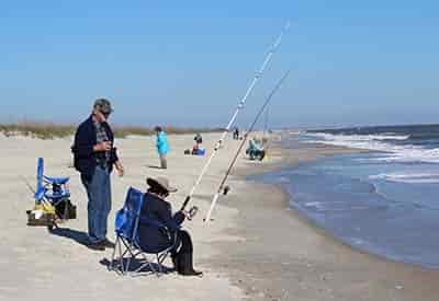 senior couple surf fishing on the outer banks