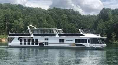125' houseboat floating in cove on a very calm water line