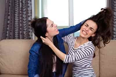 2 women pulling each others hair in argument