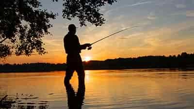sunrise fishing from the shore on a beautiful morning for fisherman