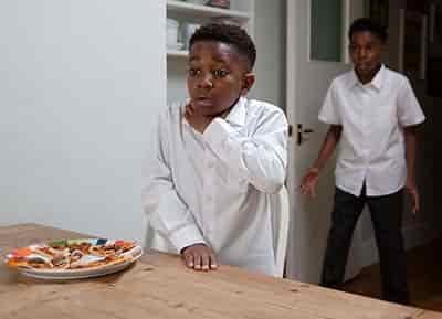 2 kids one choking on pizza the other in shock