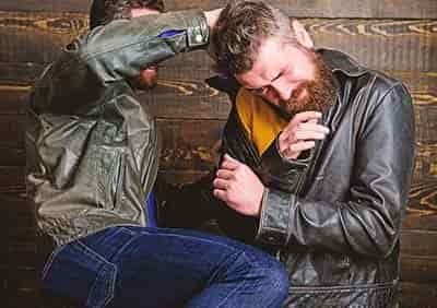 man using knee to hurt another man in fight