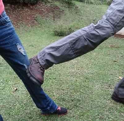 man kicking another man in the outside of knee