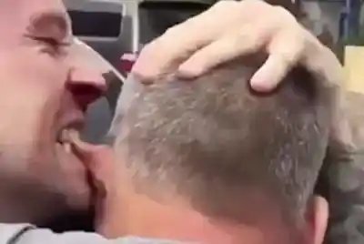 two men fighting one man is biting other mans ear while pulling it too