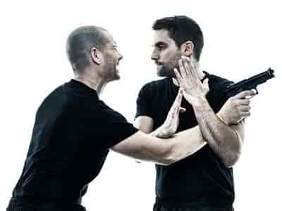 two men fighting one has a gun