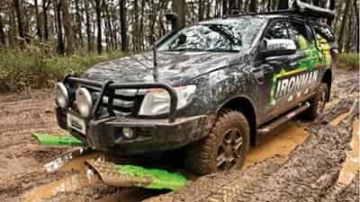 green traction recovery boards being used in mud water ditch for traction recovery