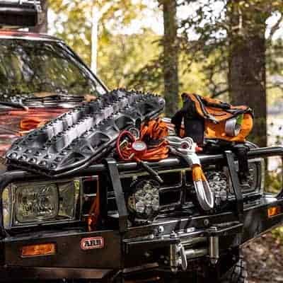 off road recovery ropes straps air compressor etc on hood of SUV
