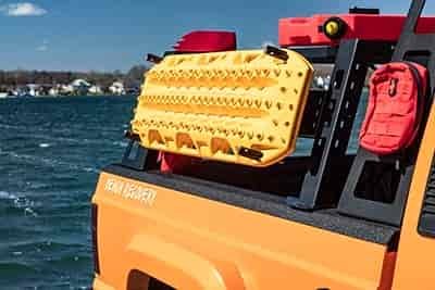 beach patrol vehicle with traction boards mounted on side of truck