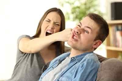 woman hitting a man in the jaw hard