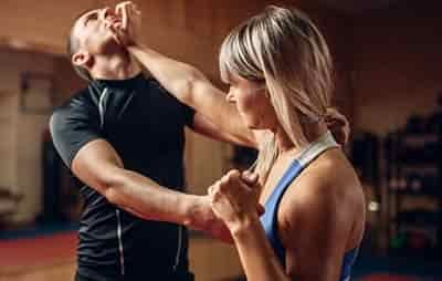 women fighting man with self defense strategy