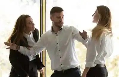 Two businesswomen having conflict at group meeting in boardroom, standing starting fight showing negative attitude colleague try to stop scuffle, confrontation, struggle for leadership at work concept