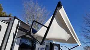 rv awning distroyed by wind and rain barreling through to carpet chairs and table