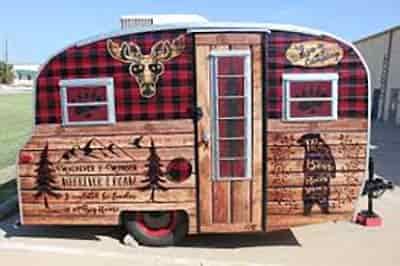 travel camper exterior new paint and detailed wrap design with bear moose head and alpine trees with plaid background