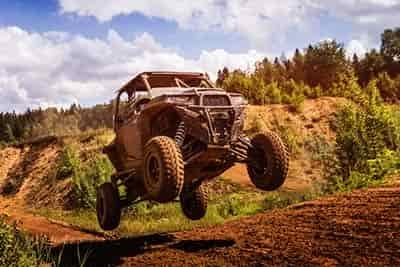 utv jumping hill in race several feet off the ground