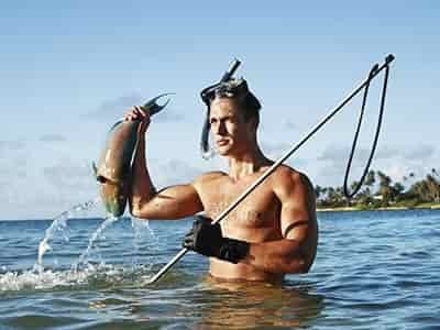 man speer fishing catch with snorkling equipment on