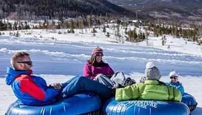four separate tubers together going down hill
