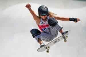 young person skate boarding at skate park