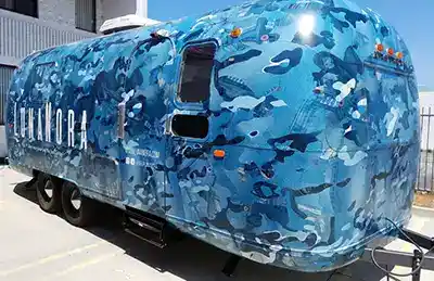 airstream with a full rv wrap blue jean pockets and sea creatures