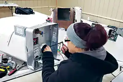 woman working on hot water heater