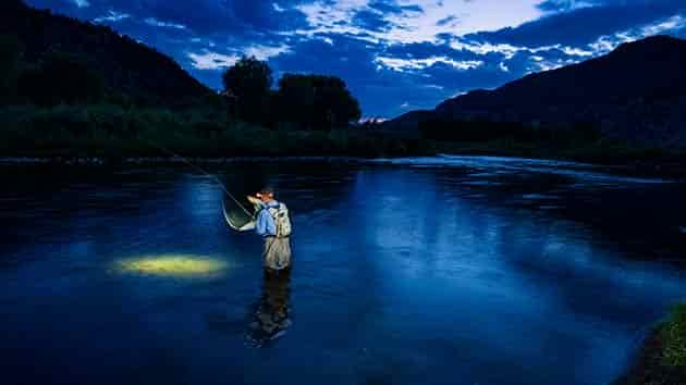 night fly fishing in a river