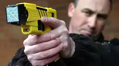tasr gun practice by man pointing at target