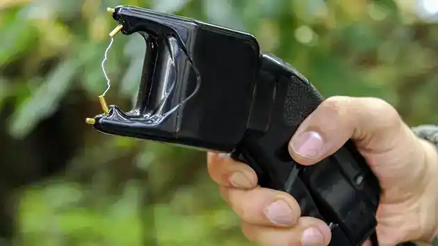 working stun gun held by young lady