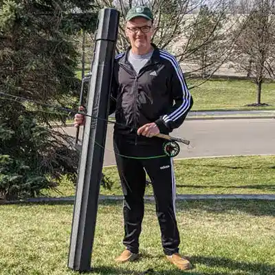 man holding fishing Rod in case on Plane