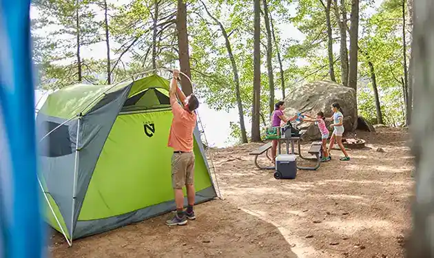 family arriving camping tent setup