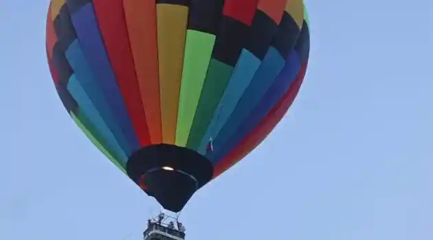 hot air balloon with riders and fire