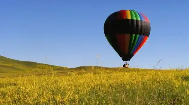 hot air balloon landing in field