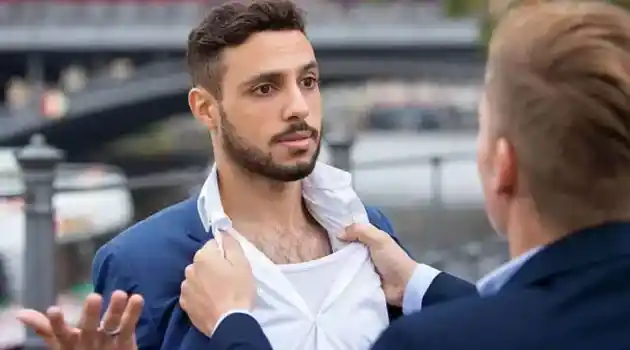 man grabbing another man to fight