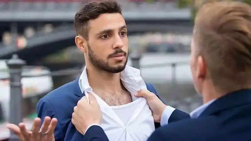 man grabbing another man to fight